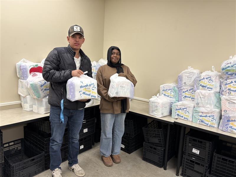 two fellows distributing diapers